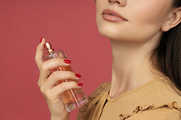 istock Beautiful bottle with perfume in hand close-up 2205462564