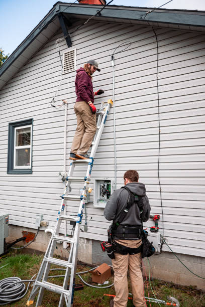 istock Electrician Wiring Up Solar Panel System on Home 2205465593