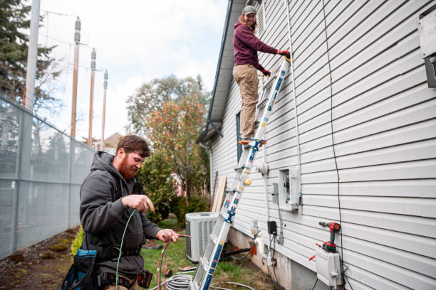 istock Electrician Wiring Up Solar Panel System on Home 2205465596