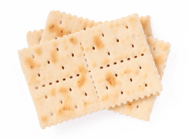 istock Crispy saltine crackers isolated on white background. 2205469364