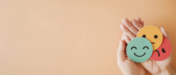 istock Hands holding emotion faces, bipolar and depression, mental health, split personality, mood change concept 2205469997