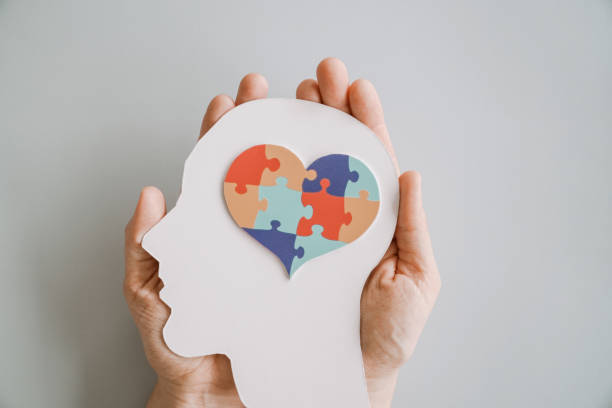 istock Hands holding jigsaw puzzle heart shape in brain Autism awareness, neurodiversity concept, World Autism Awareness Day 2205470140