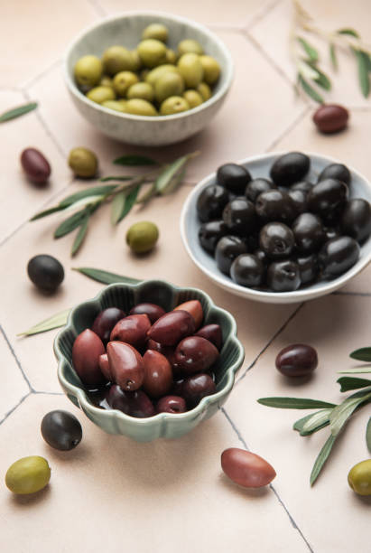 istock Assorted olives in ceramic bowls with leaves 2205471933
