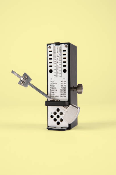Close-up of a vintage audio mixer with metallic sliders and knobs, showcasing the intricate design and functionality of sound equipment.