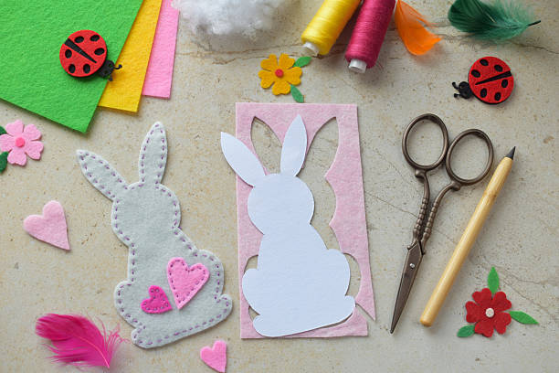 istock DIY Felt Bunny Sewing Craft with Pink Hearts and Paper Cutout. Creative Handmade Easter Decoration with Bright Fabric, Tools, and Accessories for Hobbyists and Seasonal Projects 2205474084