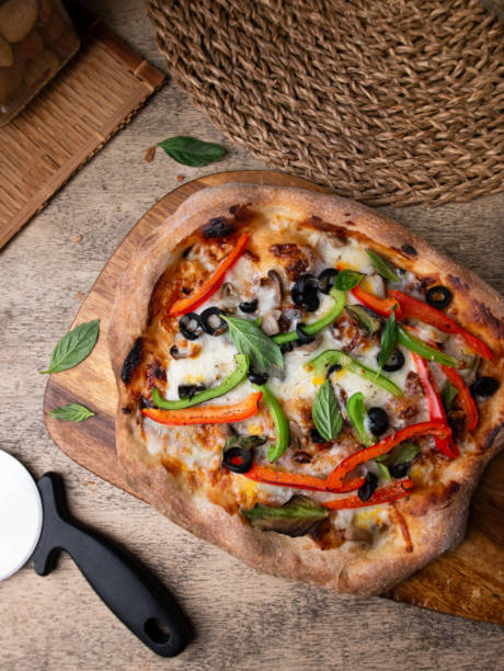 istock Homemade Sourdough pizza on Wooden Table. 2205474311