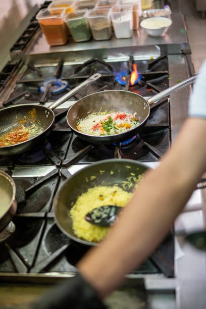 istock Chef cooking indian saffron rice in a professional kitchen 2205474832