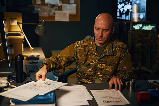 istock Working At Desk in Military Office Reviewing Documents 2205474933