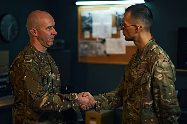 istock Military Officers Shaking Hands in Office Setting 2205475287