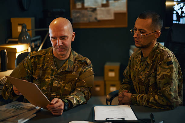 istock Discussing Operation Details in Military Office Setting 2205475358