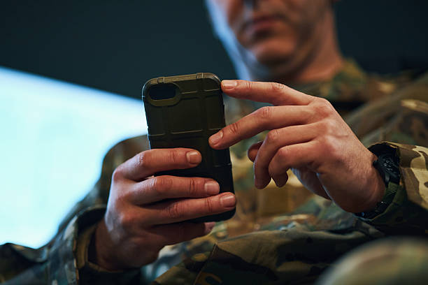 Focused Soldier Wearing Uniform Using Smartphone