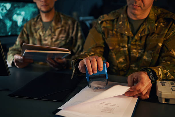 istock Reviewing Classified Documents in Military Operations Room 2205475646