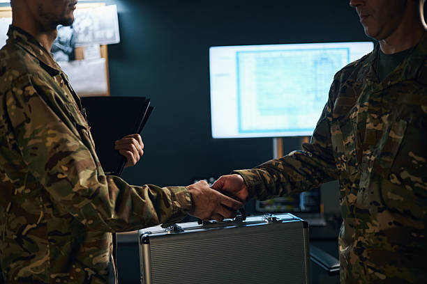 istock Handshake Between Military Personnel in Office Setting 2205475681
