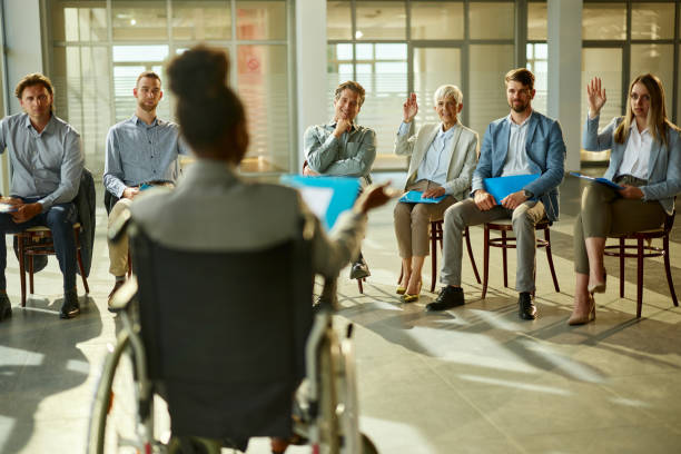 istock Happy entrepreneurs having a seminar with their disabled CEO in the office. 2205478132