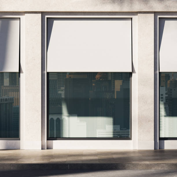 istock Modern building facade with large reflective glass windows and white retractable awnings. 3D Rendering 2205478164