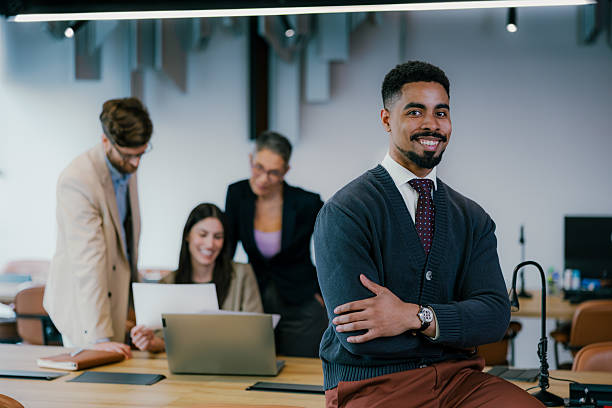 istock Confident smiling businessman leading a team meeting in modern office 2205478212