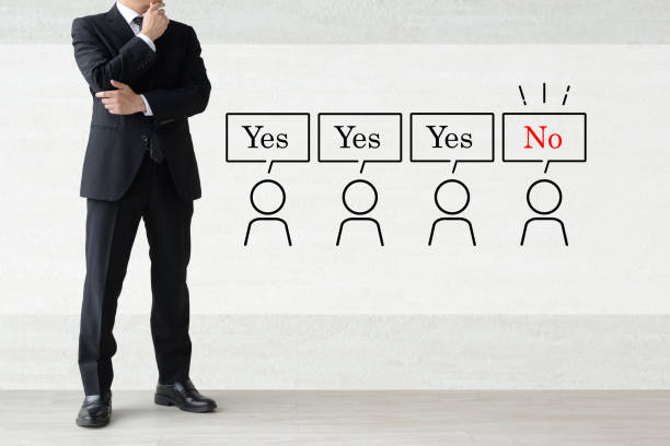 A public speaker is pointing to the blank presentation screen.