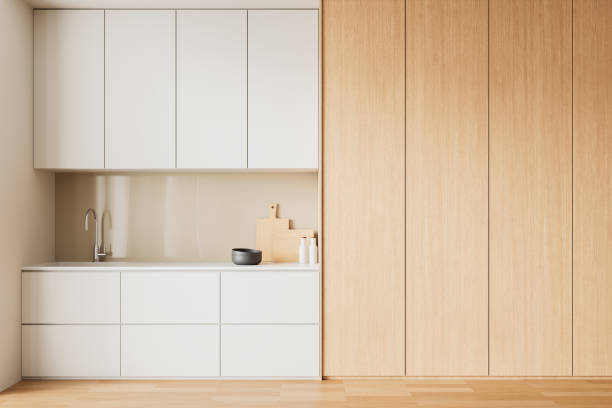 istock Modern minimalist kitchen with white and wood cabinets. 3D Rendering 2205479125