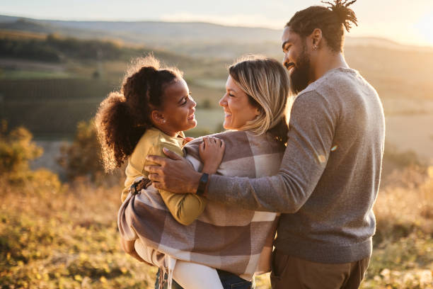 istock Happy diverse family talking while spending an autumn day in nature. 2205480351