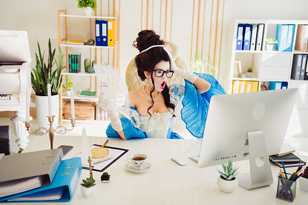 istock Elegant businesswoman dressed as a medieval duchess shocked while working in a modern office setting 2205485056