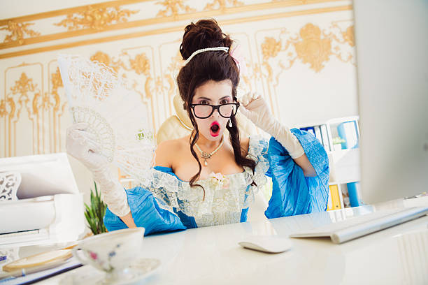 istock Elegant woman in attire interacts with modern technology intensely showcasing a blend of historical fashion and contemporary workplace 2205485062