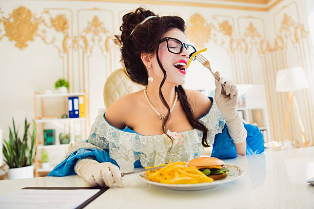 istock Classic Styled Woman Combines Royal Elegance with Modern Office Lifestyle While Enjoying a Meal 2205485116