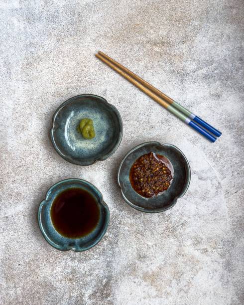 istock Ceramic dishes with condiments and chopsticks. 2205485148
