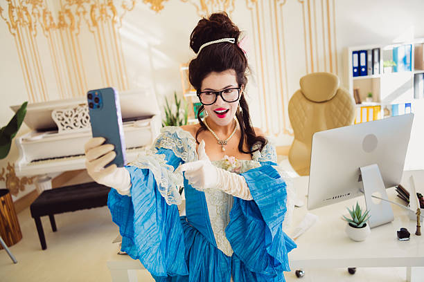 Young woman dressed in historical costume using a smartphone in a modern office, blending themes of history and technology