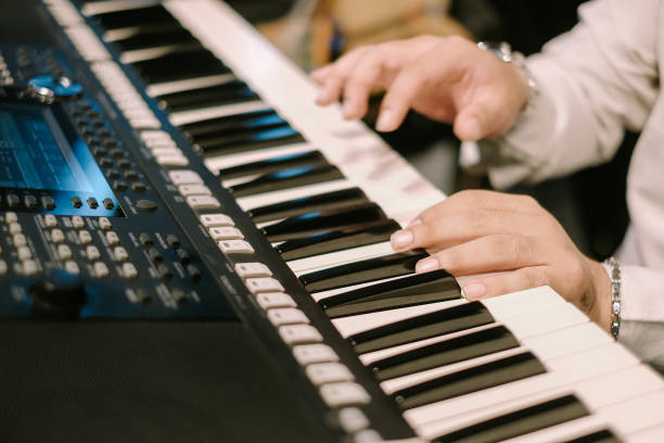 istock Hands playing electronic keyboard instrument close up view music scene 2205485353