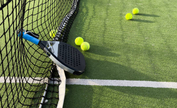 istock padel racket on a padel court with a ball 2205486379