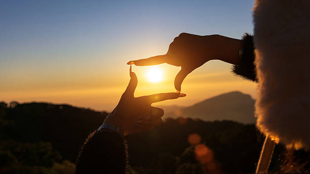 istock Closeup of female hands making frame gesture capturing sunset, Future planning concept. 2205486722