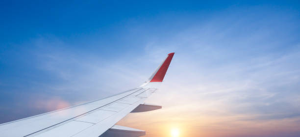 istock view from plane window of plane wing and sky sunrise 2205487960