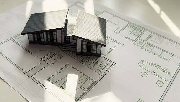 Building models and blueprints are placed on work desks in the construction engineering team offices to plan construction to achieve their goals and to simulate building models for clients to see.