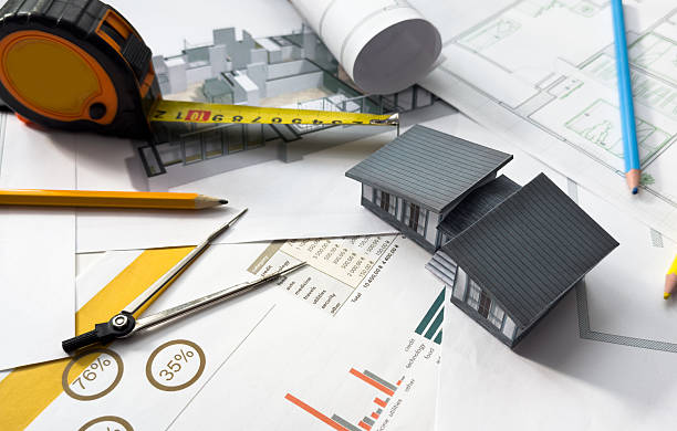 istock Building models and blueprints are placed on work desks in the construction engineering team offices to plan construction to achieve their goals and to simulate building models for clients to see. 2205489059
