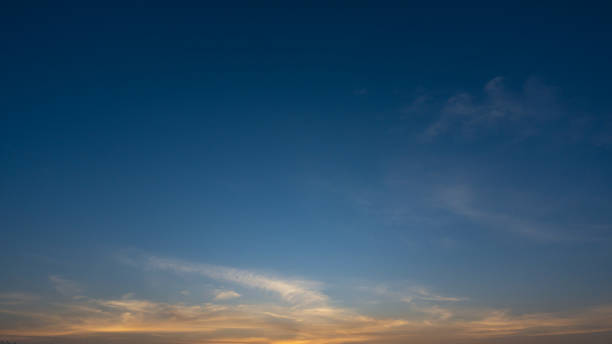 istock blue sky with soft wispy clouds at sunrise 2205489891
