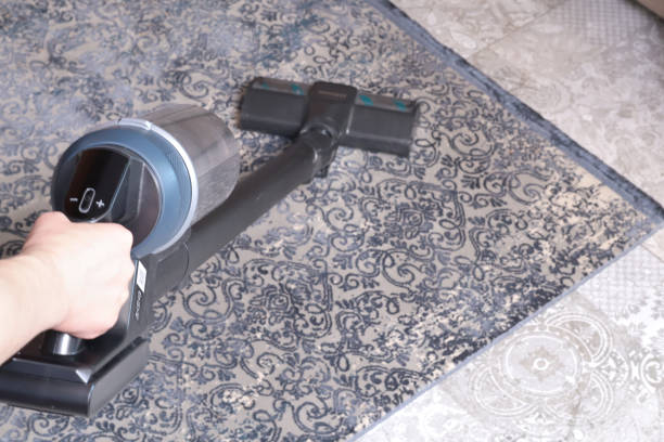 istock Modern upright cordless vacuum cleaner with dust light. 2205491460