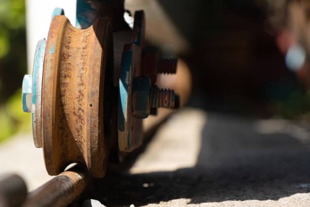 istock A rusty wheel from sliding gate on a rail, close up view 2205492429
