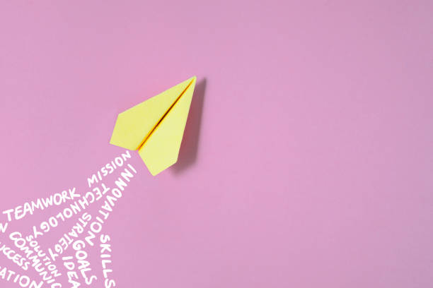 istock Paper Plane on Pink Background with Business Related Words 2205493273