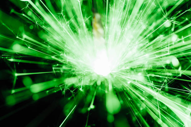 A mesmerizing green light burst radiates energy and sparkles against a dark background, creating a magical and vibrant atmosphere perfect for creative projects.
