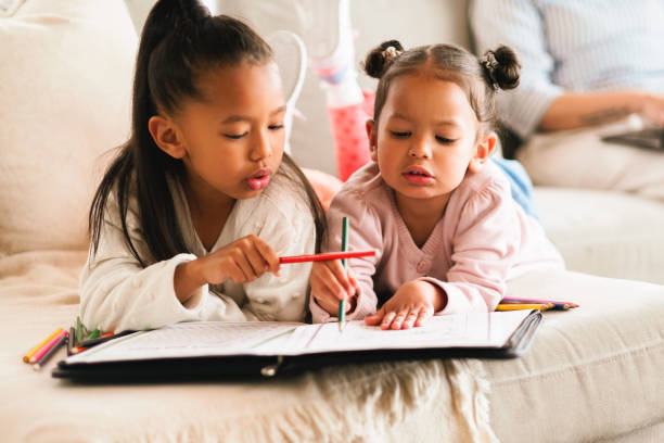 Help, sisters and children learning in home school for creative drawing, teaching or studying. Girls, siblings and color with paper on living room sofa for art, homework and education with family