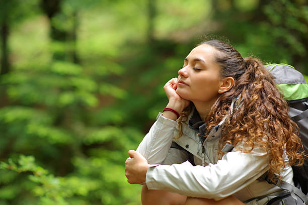 istock Hiker resting and relaxing sitting in a forest alone 2205498973