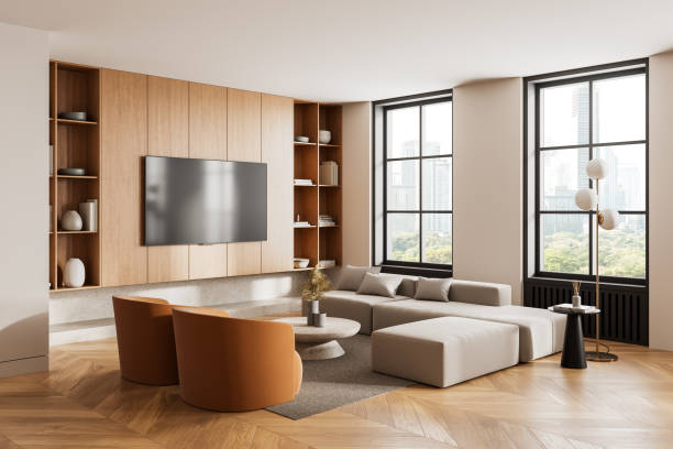 istock Modern living room with wooden panel wall, beige sectional sofa, and large windows overlooking cityscape. Elegant and warm interior design. 3D Rendering 2205500642
