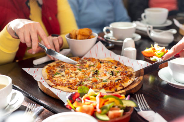 istock Tucking In To Some Pizza 2205502323