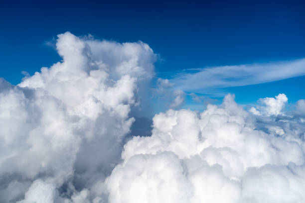istock Majestic white clouds and deep blue sky seen from an airplane 2205502424