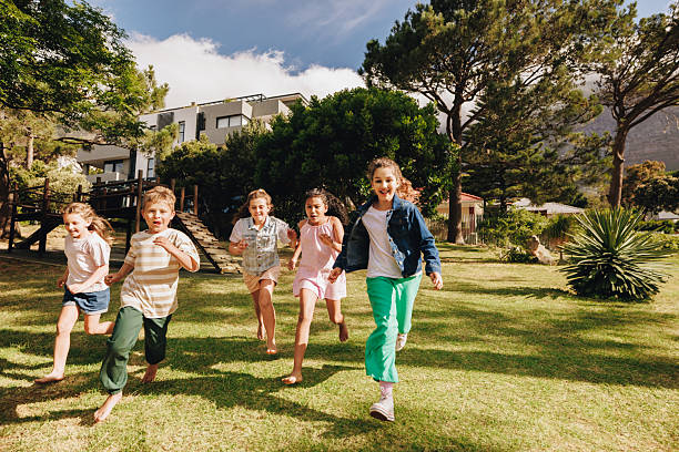 istock Children running and playing outdoors on a sunny day in a yard 2205502504