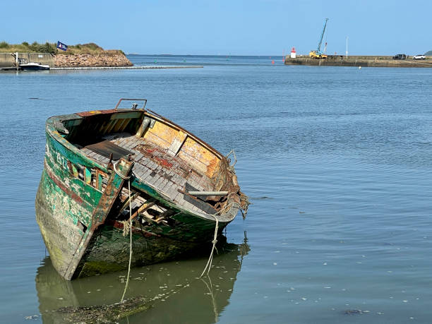 istock decaying wooden boat by bay 2205502593