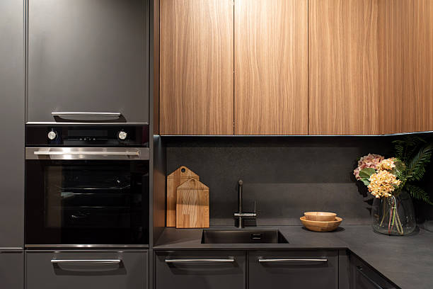 istock Modern gray kitchen with electric oven and kitchen faucet 2205503840
