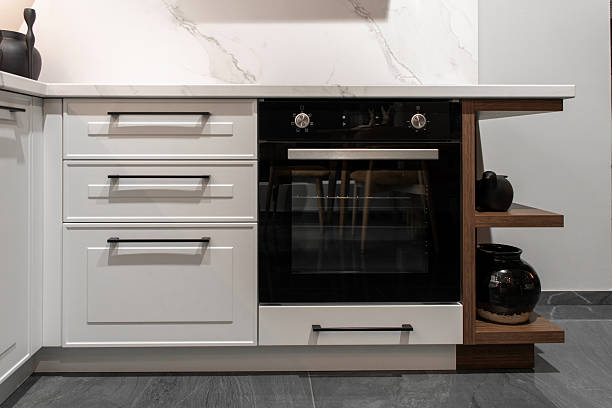 istock Built-in electric oven with sleek control panel in light wood cabinetry 2205503850