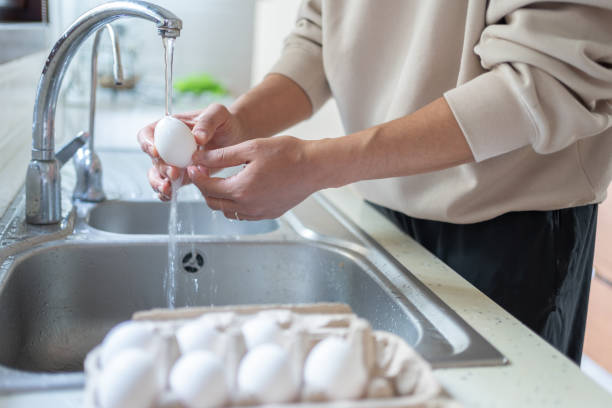 istock Washing The Eggs With Water 2205504999