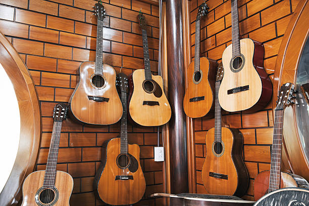 istock Classical guitars hanging on a wall in a music store. 2205505874